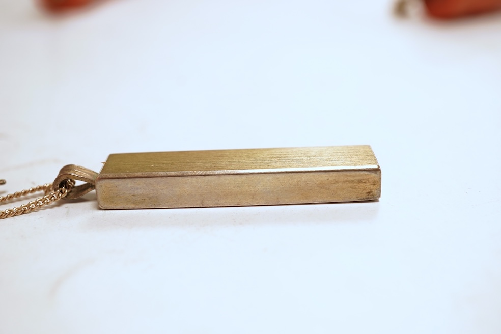 A silver necklace and bracelet, comprising: a silver ingot pendant necklace, pendant length 5.2cm including bail; and a silver curb link ID bracelet, length 20cm, each with British hallmarks, combined gross weight 82 gra